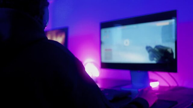 Young gamers playing online video game with computer at home. Gaming and technology