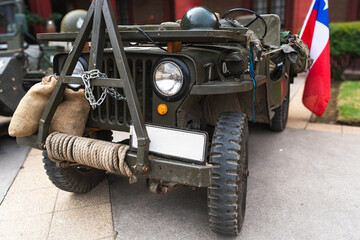 Vintage military vehicle with a Chilean flag, showcasing military gear and war history. A well-maintained defense vehicle.