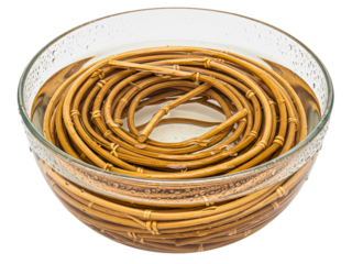 Natural rattan cane coil soaking in clear glass bowl of water on a transparent background