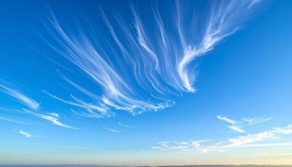 Dramatic sky of cerulean with ethereal cloud formations depicting movement and beauty