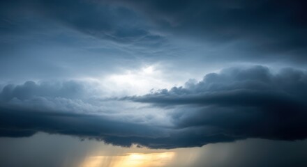 Dramatic storm clouds gathering with rays of sunlight breaking through