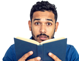 Surprised man with dark hair reads an open book, against a dark background, in blue shirt