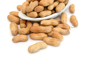 Dried peanuts in closeup on white