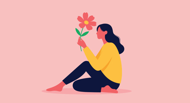 A peaceful woman sits on the floor, admiring and gently smelling a vibrant red and yellow flower, finding joy in simple pleasures.