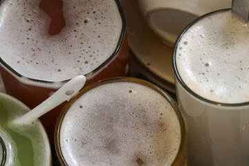 Comforting top view of several coffee cups and glasses. foamy latte and cappuccino drinks create cozy morning scene, perfect for relaxing break at cafe
