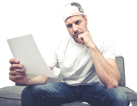 Thoughtful man in cap sits on gray couch, studying a blank white paper, hand on chin, looking at the document - Powered by Adobe
