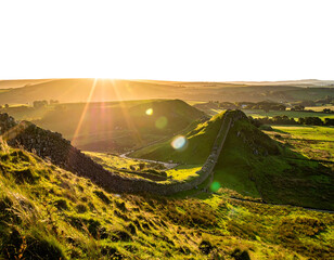 Sunlight streams over a historic stone wall snaking across green rolling hills beneath a radiant, vibrant sky