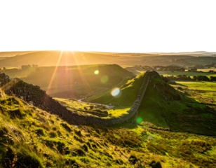 Sunlight streams over a historic stone wall snaking across green rolling hills beneath a radiant, vibrant sky
