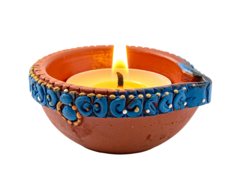 Small clay oil lamp, adorned with ornate blue details, alight. Set against a stark black background