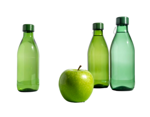 Three green bottles filled with clear liquid and a bright green apple, set against a stark black background