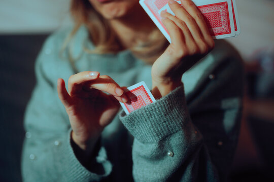 Woman Plays Cards Puts a Card Up Her Sleeve to Cheat. Deceptive game player trying dishonest tactics
