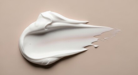 Creamy white cosmetic product smear with a textured surface against a neutral beige background, revealing smooth, flowing curves in a macro shot emphasizing its delicate and luxurious appearance.