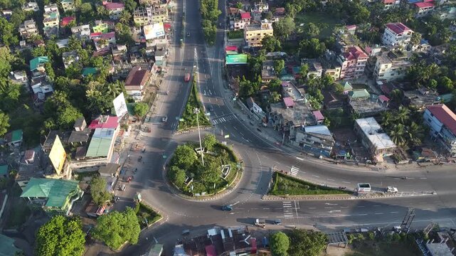 birds eye view video clip of vehicles in motion on a roundabout traffic point during early morning time in India