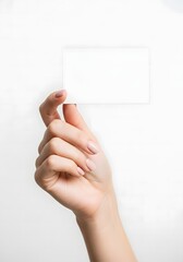 Hand holding blank white card against white background