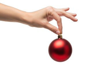 Hand holding a red christmas ball, ready to decorate the christmas tree