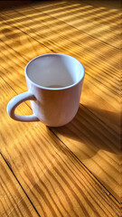 White Ceramic Coffee Mug Bathed in Morning Sunlight Across Warm Wooden Table Still Life Scene