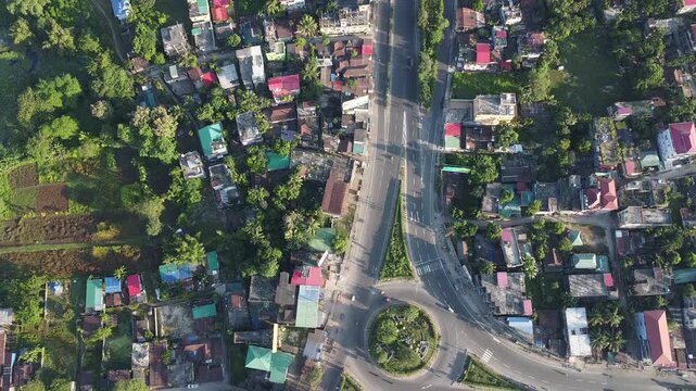 birds eye view video clip of vehicles in motion on a roundabout traffic point during early morning time in India