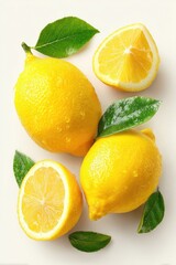 Bright yellow lemons & green leaves on cream backdrop