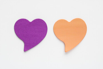 Two heart-shaped sticky note or cutout, isolated on a clean white background, ideal for notes, reminders, or creative projects, representing love, affection, and care.