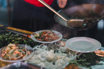 Stir-fried food, being served on a plate, being served on a plate