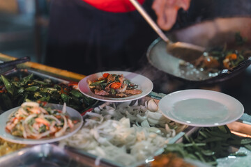 Stir-fried food, being served on a plate, being served on a plate