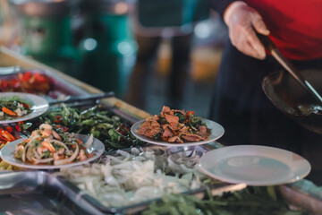 Stir-fried food, being served on a plate, being served on a plate