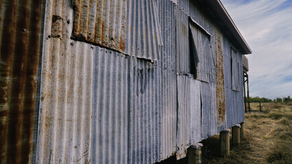 weathered corrugated metal shed with rustic and industrial texture in a rural landscape