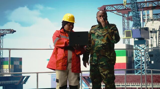 Soldier working on offshore platform communicating via military radio. Naval unit boarding drilling barge under maritime interdiction protocol, speaking on tactical walkie talkie, camera A