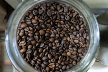 Fototapeta premium Coffee Bean Dream Top View of Roasted Beans in Glass Jar with Rustic Charm.