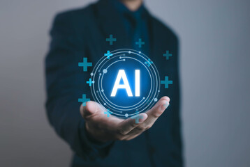 Businessman holding AI technology icon with digital interface. Concept for artificial intelligence, innovation, automation, data analysis, and future technology in business.