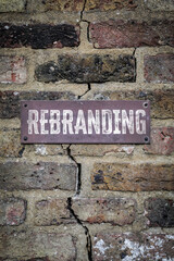Rebranding Concept. Metal sign mounted on an aged brick wall, symbolizing change, renewal and modern business transformation