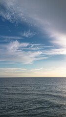 Calm Ocean View with Blue Sky and Clouds