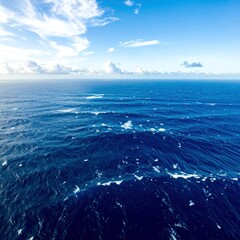 Fototapeta premium Aerial view of the vast ocean with deep blue water and gentle waves rolling below.