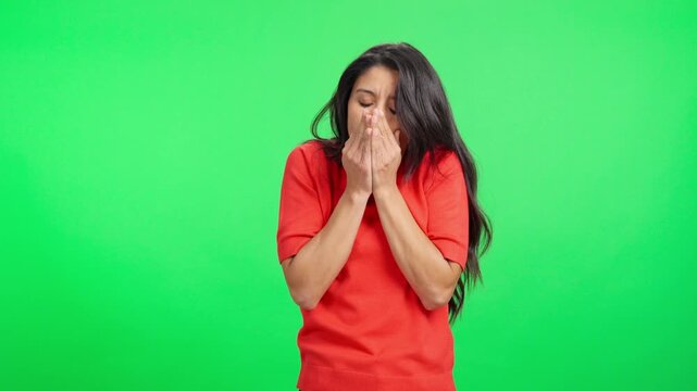 Freezing young woman shivering from cold on green screen