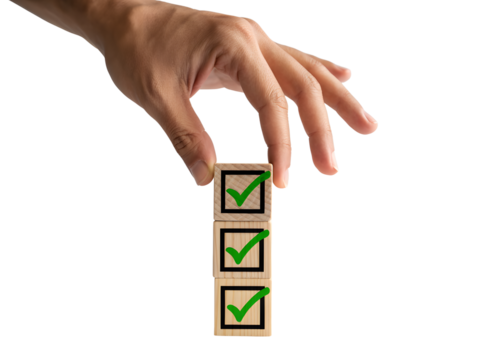Hand stacking wooden blocks with check marks isolated on transparent background