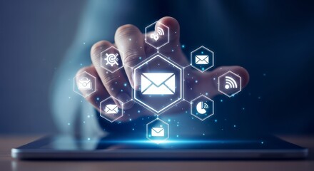 Hand touching tablet with email icons and other business symbols in a digital interface concept