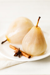 Poached pears with spices in syrup.