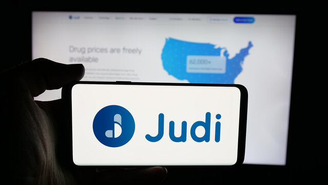 Stuttgart, Germany - 10-24-2025: Person holding cellphone with logo of healthcare platform company Judi Health LLC on screen in front of webpage. Focus on phone display.