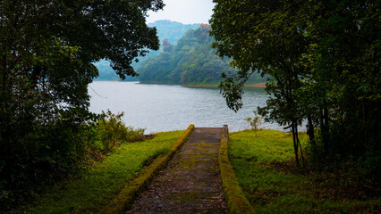 Palakkad, Kerala, India - October 2025: A serene view of the Siruvani Dam surrounded by lush green...
