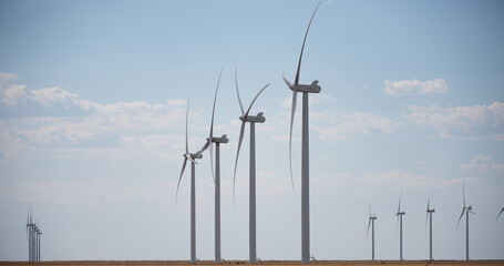 Wind turbines generating renewable energy in motion. Power technology. Wind turbines producing...