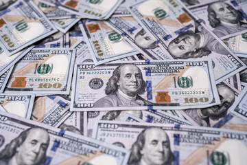 Money background with 100-dollar bills. Texture of US money currency. 100 USD banknotes in focus. American hundred-dollar money backdrop. Pattern of US dollars. Money for finance concept.