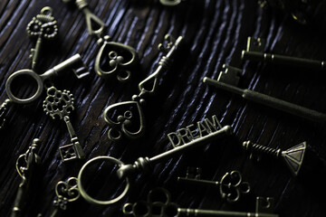 Vintage Skeleton Keys on Dark Wooden Surface, Close-Up Detail of Antique Bronze Keys