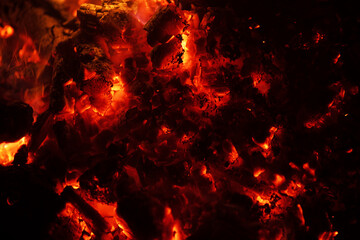 Glowing embers fire background. Burning fire charcoal texture. Hot coals close-up. Fiery pattern....