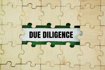 Wooden puzzle with the word due diligence. financial concepts. reasonable steps taken by a person to avoid committing a tort or offence.