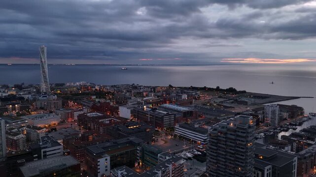 Drone glides over Malm&ouml; harbor bathed in soft summer evening light