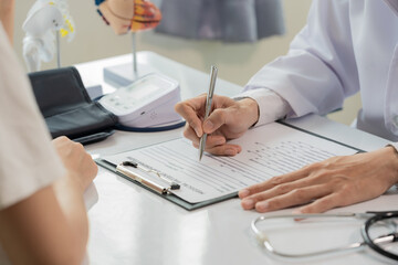 Doctor and patient discussing brain treatment while sitting at table. Concept of medicine and healthcare.