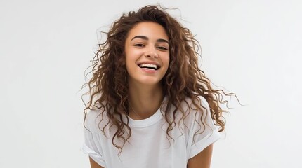 Girl about 18 years old wearing a white t-shirt on a white background. Cheerful, happy attitude. horizontal video 