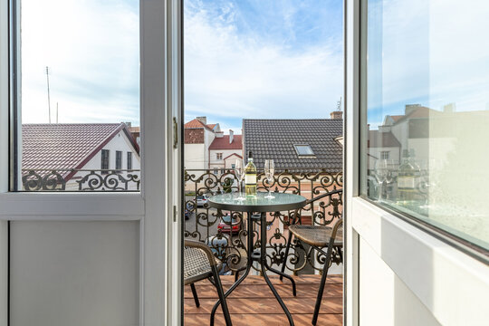 Elegant Balcony with Wine and Scenic European Rooftops