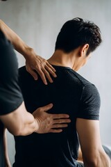 Physiotherapist Massaging Man’s Shoulder and Back to Relieve Muscle Pain