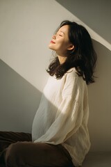 Portrait of a pregnant woman sitting with a relaxed smile